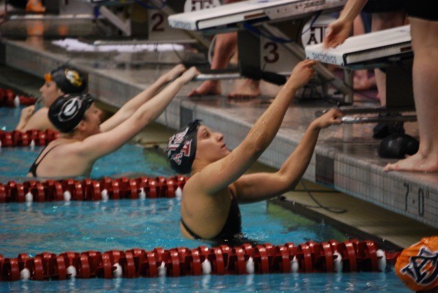 Texas A&M's Lili Ibanez is congratulated by teammates after they broke the SEC Championship Record in the 400 medley relay. Credit: Janna Schulze