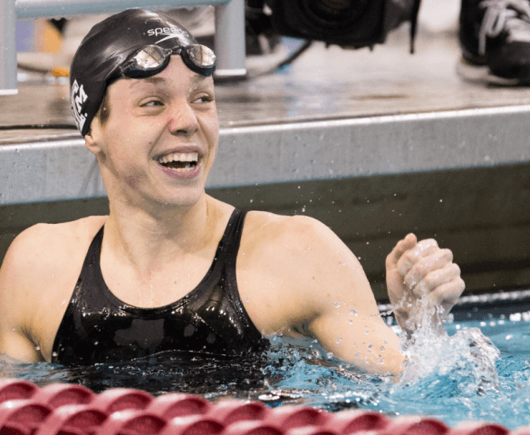 Paige Miller, Texas A&M, wins the 100 backstroke at the 2014 NCAA Women's DI Swimming & Diving Championships (Tim Binning, theswimpictures)