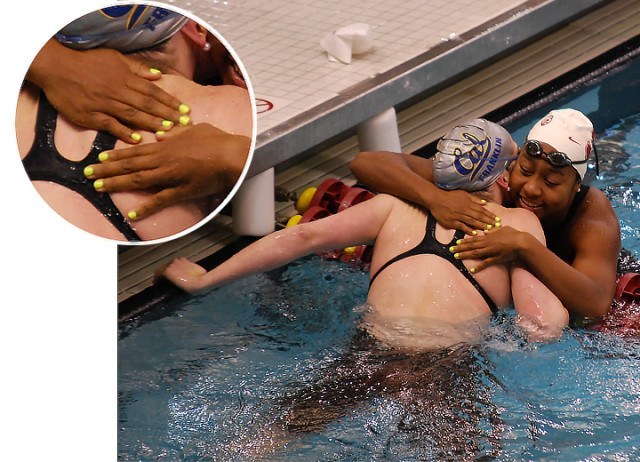 Lia Neal of Stanford has yellow nails as she hugs Missy Franklin after the 400 medley relay. Don't worry though, That's definitely not "Cal" yellow. (Courtesy: Janna Schulze)