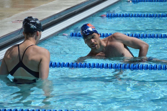 Nick Thoman and masters swimmer participant discuss backstroke finishing technique - Fitter and Faster Swim Tour Bethesda, MD Clinic