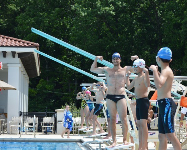 Nick Thoman and participants showing off their muscles - Fitter and Faster Swim Tour Bethesda, MD Clinic