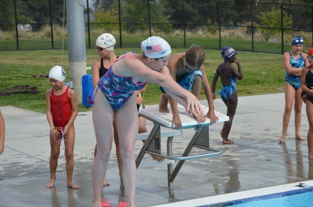 Kara Lynn Joyce helps participants with start technique - the Fitter and Faster Swim Tour in Yucaipa, CA.
