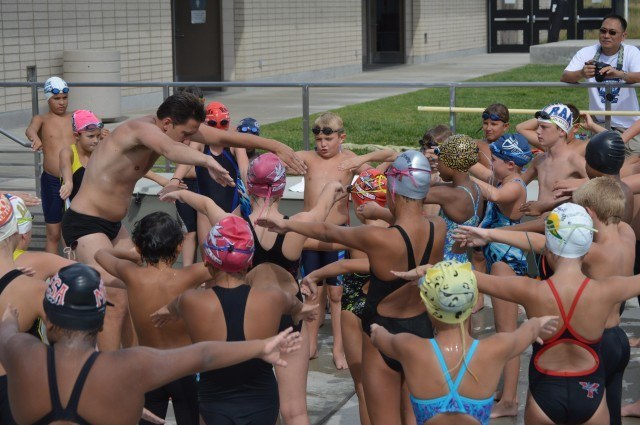 Mark Gangloff and participants going over breaststroke drills before getting in water.- the Fitter and Faster Swim Tour in Yucaipa, CA.