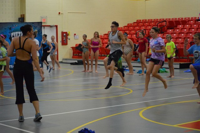 Lacey Nymeyer leading participants in a dynamic warmup - Fitter and Faster Swim Tour presented by SwimOutlet.com.