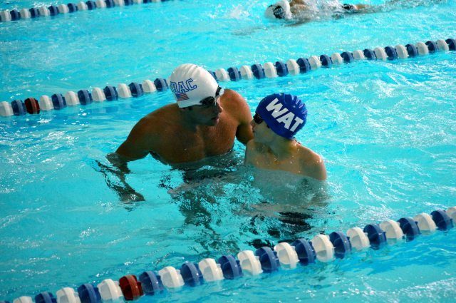 Oregon, WI - Tom Luchsinger helps a young swimmer with butterfly technique - Fitter and Faster Swim Tour presented by SwimOutlet.com