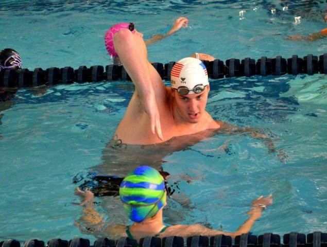 Pittsburgh, PA - Jimmy Feigen works on a high elbow with a swimmer - Fitter and Faster Swim Tour presented by SwimOutlet.com