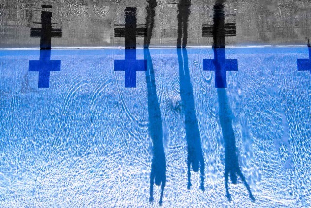 This shot was made mid summer in La Jolla, California. The swimmers were just getting ready to jump in the water when their shadows cast long down the wall. (photo: Mike Lewis, Ola Vista Photography)