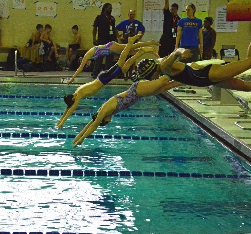 Katie Hess, 10 of La Grange, Ethan Baum, 10, Molly Norgle, and Emily Claesson, 10 all from Lyons Aquatics practice their starts off the block during warm-ups at Lyons Aquatics County Line Classic meet Feb 14.