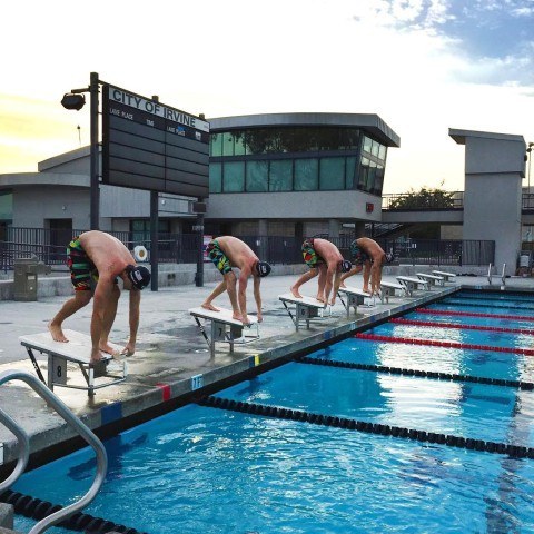 Nick Thoman, Michael McBroom, Josh Schneider and Matt Grevers sporting their TYR Avictors while taking their marks on the starting block.