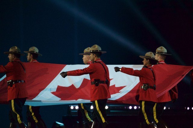 Toronto -- RCMP carry the Canadian flag into the opening ceremonies of the Toronto 2015 Pan Am games at the Pan Am Dome. July 10, 2015.