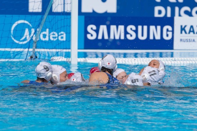 The Japanese women's water polo team gathers before the start of their match against the USA in the preliminary round at the 2015 FINA World Championships held in Kazan, Russia July 24-August 9, 2015. (courtesy of Tim Binning, theswimpictures.com)
