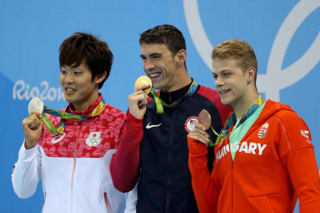 Masato Sakai, Michael Phelps, Tamas Kenderesi - Olympic Podium - gold - 200 fly - 2016 Rio Olympics/photo credit Simone Castrovillari