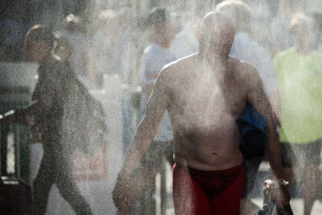 Beating the 100 degree heat with the misters on deck at the 2016 US Masters Swimming National Championship (Photo: Mike Lewis - Courtesy of U.S. Masters Swimming)